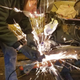 My friend Mike wearing the proper safety equipment while using an angle grinder to cut my frame.